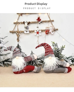 Close-up of handmade Christmas gnomes with knitted hats and white beards for home decor
