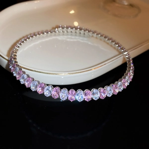 Elegant silver-tone tennis bracelet featuring pink and white oval-cut zircon gemstones