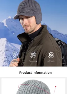 Detail of grey winter knit cap with plush lining and ear flaps against snow mountains