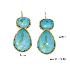 Detail view of gold drop earrings with blue crystal gemstones and product dimensions