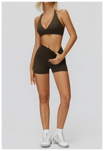 Close-up of dark brown high-waisted yoga shorts with ruched detail and crossover waistband