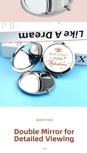 Detail view of foldable silver metal makeup mirror with a double magnification feature