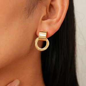 Golden earrings set with polished broad hooks and textured triple intertwined circles