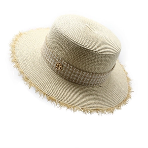 Detail of raffia straw hat showing fringed brim, plaid ribbon and gold M letter buckle