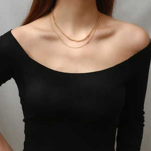 Double-layered gold stainless steel Figaro necklace worn by model for elegant layering