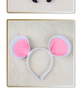 Detailed view of plush pink and white mouse ear headband on a delicate lace background