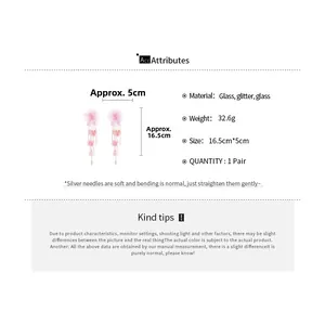 Detailed view of pink floral tassel earrings with silver needles and glass glitter beads