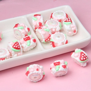 Close-up of pink strawberry cake style acrylic beads with central holes for DIY jewelry