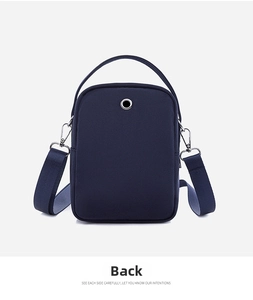 Rear view of dark blue Oxford fabric crossbody phone bag showing headphone jack hole
