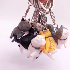 Adorable resin cat keychains with bow ties and metal rings shown in multiple colors