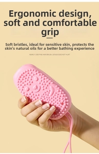 Pink silicone bath brush featuring soft dense bristles and a convenient hanging loop