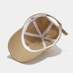 Inside view of khaki cotton baseball cap with sweatband and adjustable metal buckle