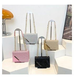 Detail view of stylish glitter chain bags in pink, silver, gold, and black colors