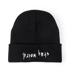 Close-up of inverted stay weird embroidery on a black knitted winter beanie hat