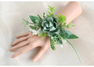 Detail of forest green silk rose wrist corsage with eucalyptus leaves and small white flowers
