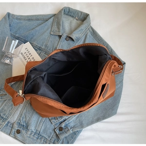 Top view of large brown canvas tote bag showing interior lining and zipper pocket