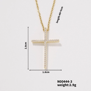 Detail view of gold cross pendant necklace with measurements and sparkling cubic zirconia