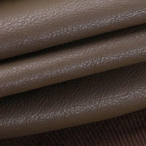Macro shot of brown PU leather texture with dark brown ribbed knit hem detail