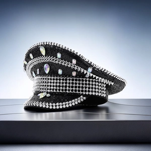Close-up of black captain hat with silver punk spikes and colorful iridescent rhinestones