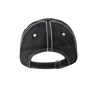 Detail of black washed denim baseball cap with white contrast stitching and metal buckle