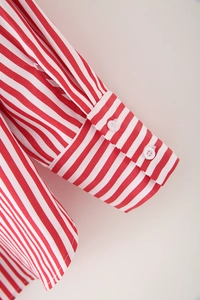 Detail of red and white striped cotton shirt cuff featuring double white buttons