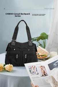 Close-up of black water-resistant nylon tote bag with functional double front zipper pockets