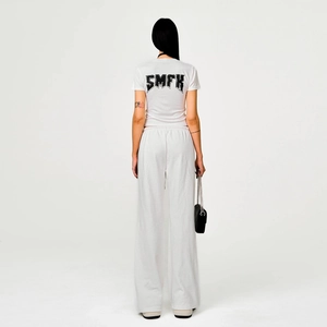 Streetwear set featuring white wide-leg sweatpants and back-print t-shirt for women