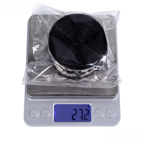 Black Halloween spider web ribbon roll on digital scale weighing 27.2g at 10m length
