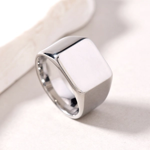 Macro shot of silver polished stainless steel signet ring with a smooth mirror finish