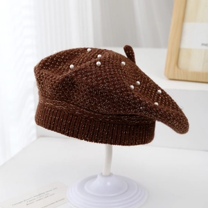 Detail of dark brown knitted beret for girls with pearl beads and shimmering metallic thread