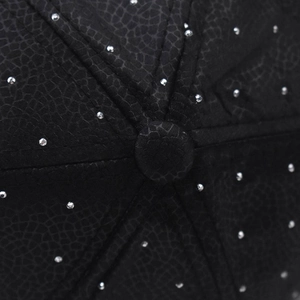 Macro detail of black snake pattern baseball cap featuring silver rhinestones and top button