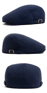 Detail view of navy cotton knit newsboy cap with antique bronze metal adjustment buckle
