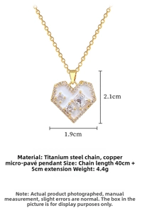 Detail view of heart necklace with white enamel and cubic zirconia in gold steel