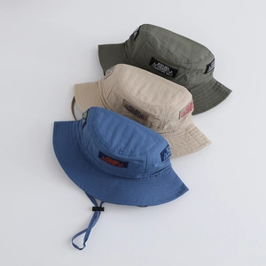 Detail of outdoor kids bucket hats with adjustable chin straps and mountain logo patches