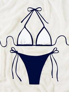 Detailed view of navy blue side-tie bikini bottoms and contrast piping on the top