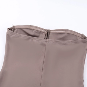 Detail view of anti-slip silicone strip on brown knitted strapless dress fabric
