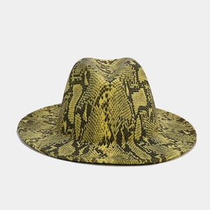 Detail of elegant yellow snake print fedora hat with wide brim and wool texture