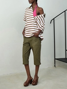 Pink halter top and striped shirt with olive cargo pants and brown platform sandals