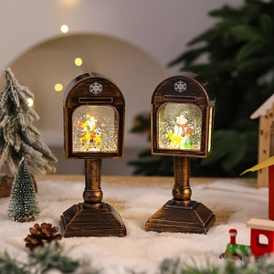 Detailed view of vintage bronze Christmas postbox LED lanterns with Santa and snowman scene