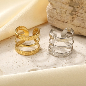 Vintage three-layer embossed open rings in gold and silver with textured hammered finish