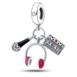 Detail of music charms with microphone and Life is a mix tape engraving on a tape