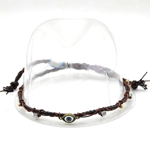 Close-up of brown braided PU leather hat band with evil eye charm and metal beads