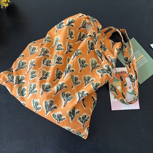 Indian block print orange cotton tote bag with green leaves floral patterns