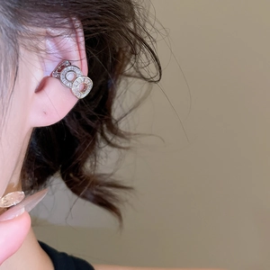 Silver zircon roman numeral ear cuff shown on ear with elegant polished metal finish