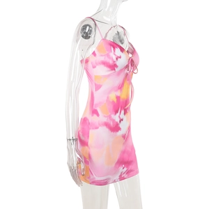 Detail view of pink tie-dye mini dress with spaghetti straps and front lace-up design