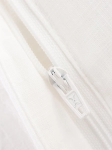 Close-up of a white invisible zipper and textured fabric on the kimono-style suit