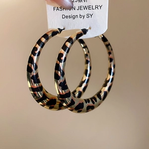 Detailed view of oversized leopard print acrylic hoop earrings with 925 silver pins