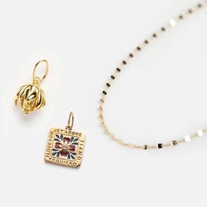 Gold-plated floral necklace featuring lily of the valley charm and I LOVE YOU enamel pendant
