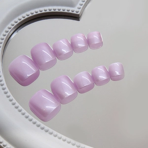 Fluorescent purple press-on toenails with cat-eye pearl finish on a mirrored tray
