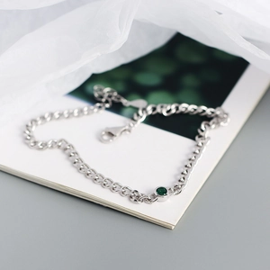 S925 sterling silver tank chain bracelet with a round green gemstone on a white background